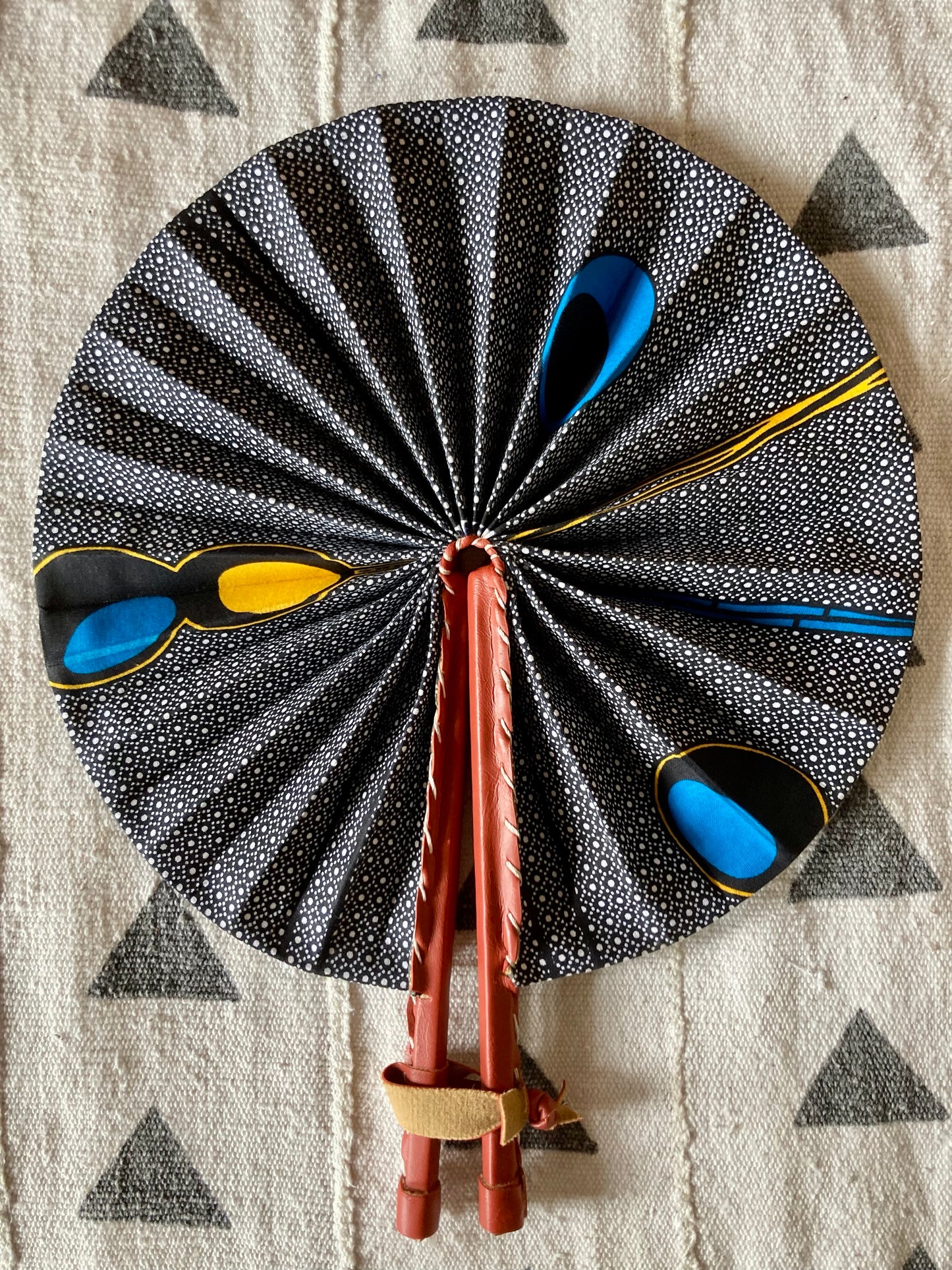 Fan- Collapses for easy storage, made from African wax fabric